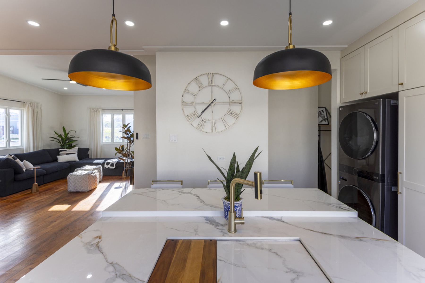 Main House kitchen — marble waterfall island and dome pendants